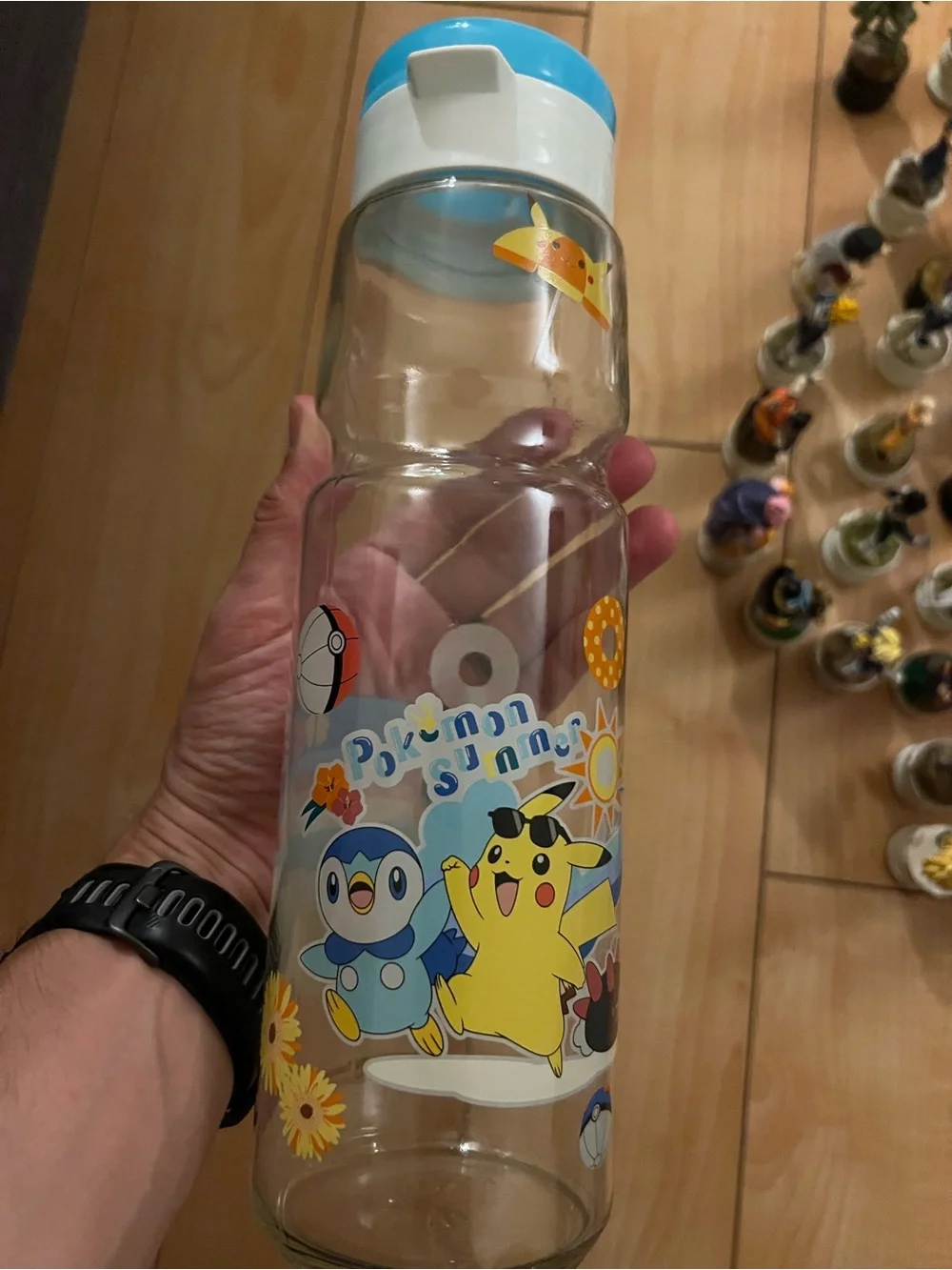 Pokemon Charmander Clear Water Bottle with Blue Cap and Rainbow Beach Art